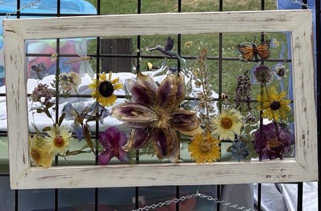 Framed dimensional piece with a large purple lily and layered wildflowers