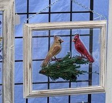 Framed dimensional piece with a pair of cardinals on a pine branch
